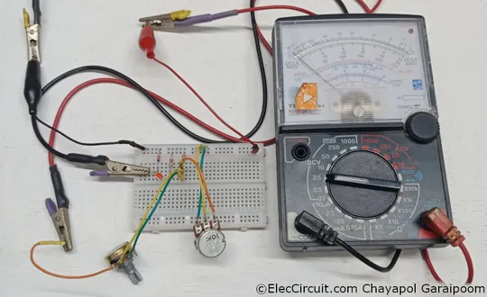 Expanded-scale voltmter assembled on breadboard and connected to an analog voltmeter.